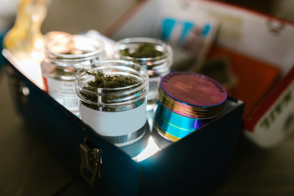 Small jars of cannabis displayed in a tin