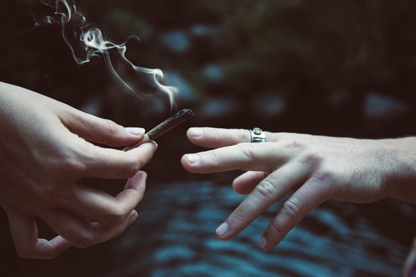 Two people sharing a joint